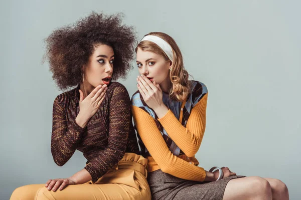 Multicultural retro styled girls gossiping isolated on grey — Stock Photo