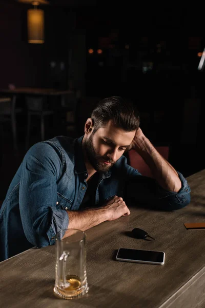 Tired visitor sitting at bar counter in evening — Stock Photo