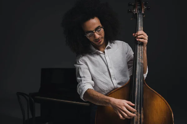 Feliz joven músico tocando el bajo standup - foto de stock