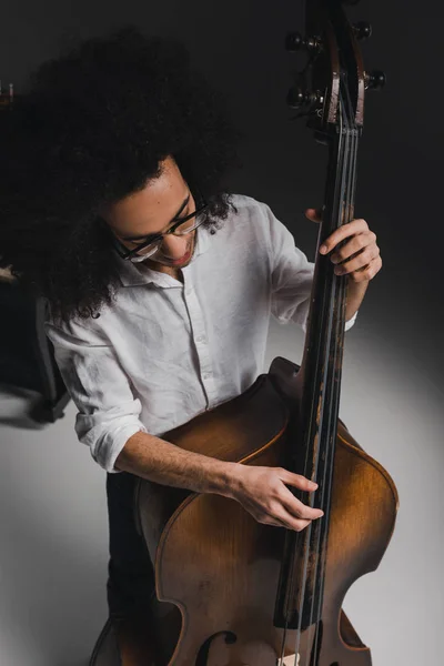 High angle view young man playing standup bass — Stock Photo