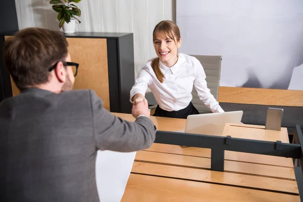 Business colleagues shaking hands of each other at workplace — Stock Photo