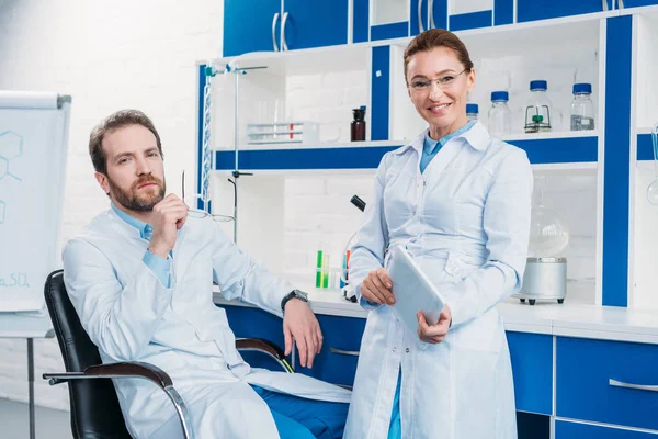 Portrait of scientific researchers in lab coats with digital tablet in laboratory — Stock Photo