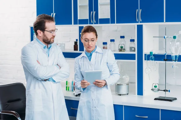 Retrato de pesquisadores científicos em jalecos com tablet digital em laboratório — Fotografia de Stock