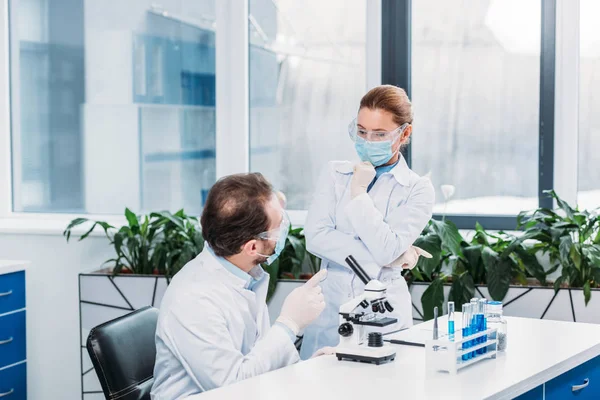 Scientists having discussion at workplace in laboratory — Stock Photo