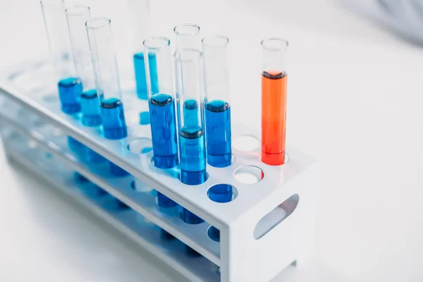 Close up view of reagents in glassware isolated on white tabletop — Stock Photo