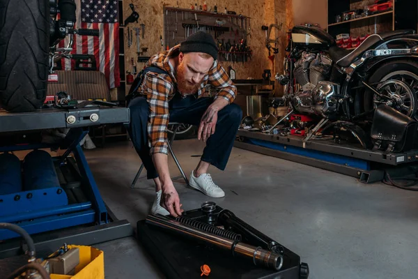 Handsome bike repair station worker at garage — Stock Photo