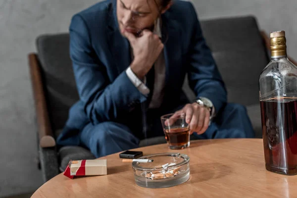 Drunk depressed businessman with glass of whiskey — Stock Photo