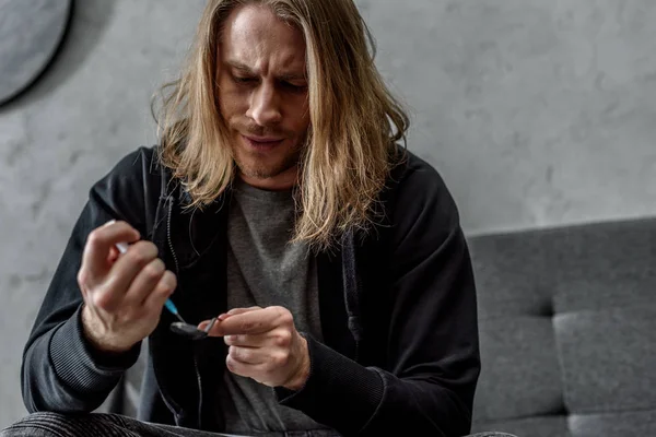 Close-up shot of addicted junkie boiling heroin in spoon with lighter — Stock Photo