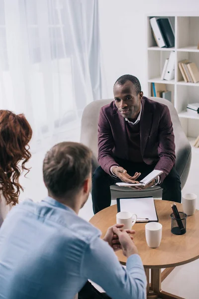 African american counselor talking to divorcing couple in office — Stock Photo