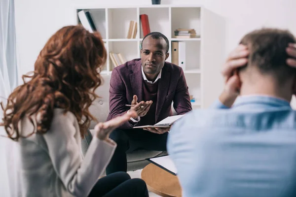Frustrated divorcing couple and african american counselor in office — Stock Photo