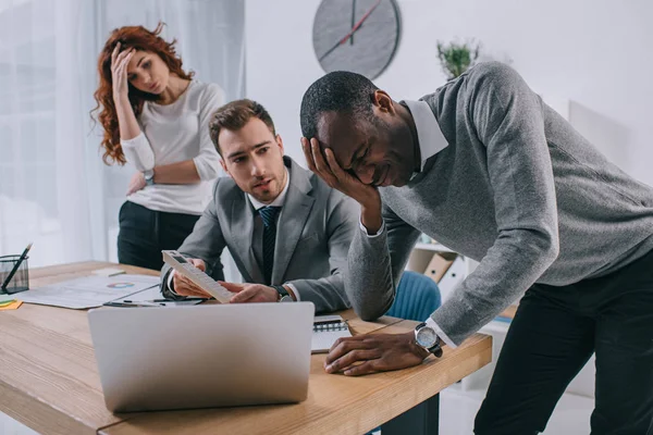 Financial adviser showing calculation to upset business partners — Stock Photo