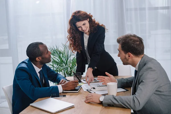 Estate broker showing documents to clients — Stock Photo