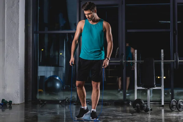 Sportsman doing cardio training with skipping rope in gym — Stock Photo