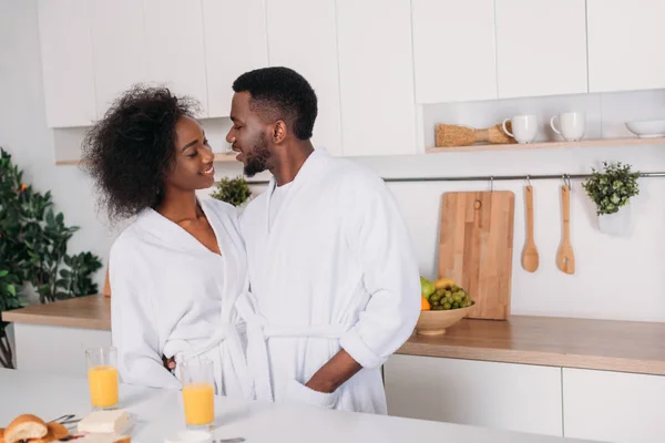 Young african american couple standing at table in kitchen — Stock Photo