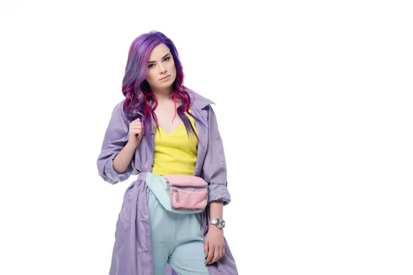 Attractive young woman with purple hair in trench coat with waist pack isolated on white — Stock Photo