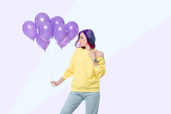 Attractive young woman holding bunch of helium balloons on creative background — Stock Photo