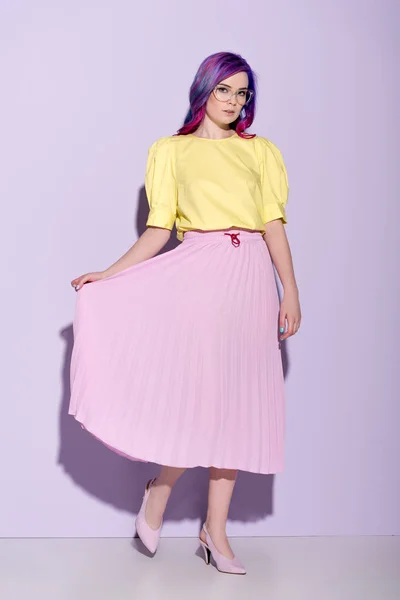 Attractive young woman with colorful hair in skirt on pink — Stock Photo