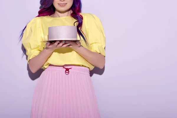 Cropped shot of smiling woman with colorful hair holding birthday cake — Stock Photo
