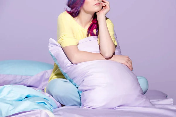 Cropped shot of thoughtful young woman sitting in bed — Stock Photo