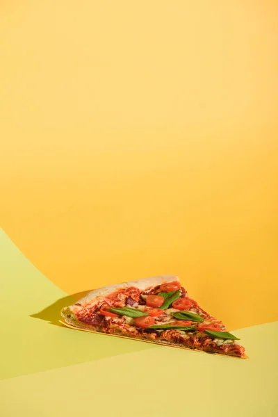 Close up view of piece of pizza with cherry tomatoes and basil on colorful backdrop — Stock Photo