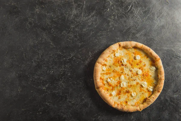 Top view of cooked italian pizza on dark tabletop — Stock Photo