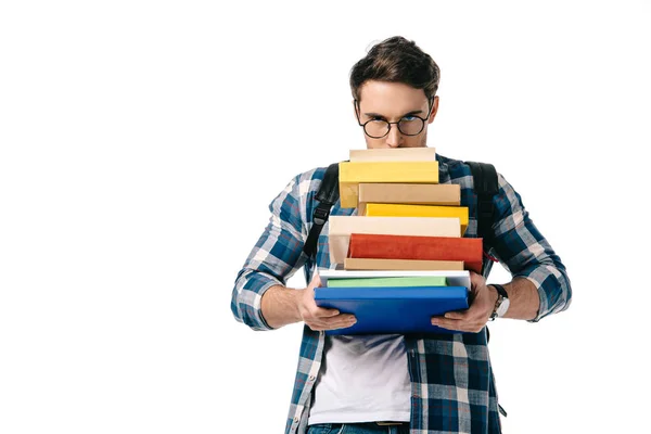 Handsome student looking out from stack of books isolated on white — Stock Photo