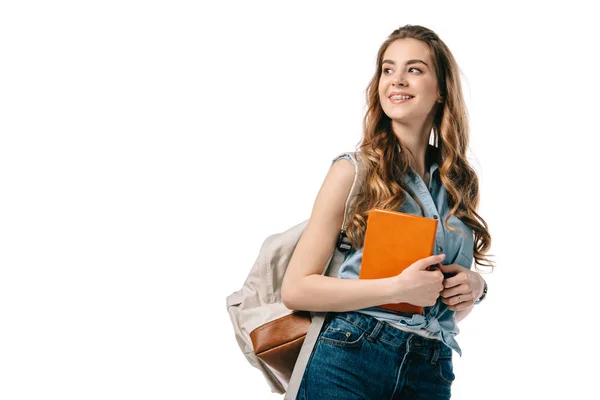 Schöne Studentin hält Buch in der Hand und schaut isoliert auf weiß weg — Stockfoto