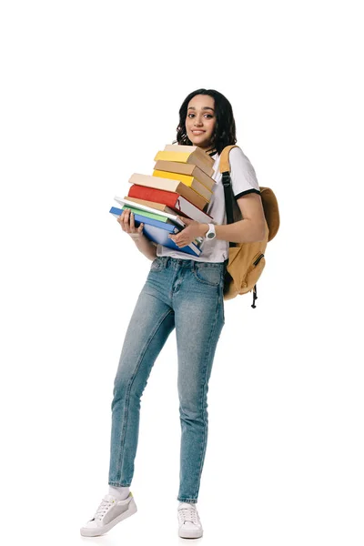 African american teen student holding heavy stack of books isolated on white — Stock Photo