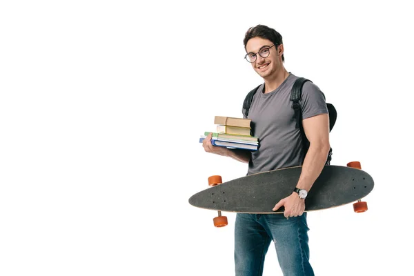 Щасливий красивий студент тримає книги і ковзани ізольовані на білому — стокове фото