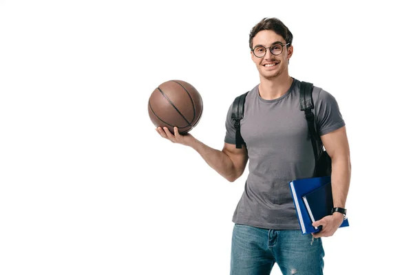 Sonriente guapo estudiante sosteniendo baloncesto bola aislado en blanco - foto de stock