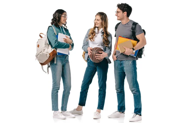 Studenti multiculturali con libri e pallone da basket isolato su bianco — Foto stock