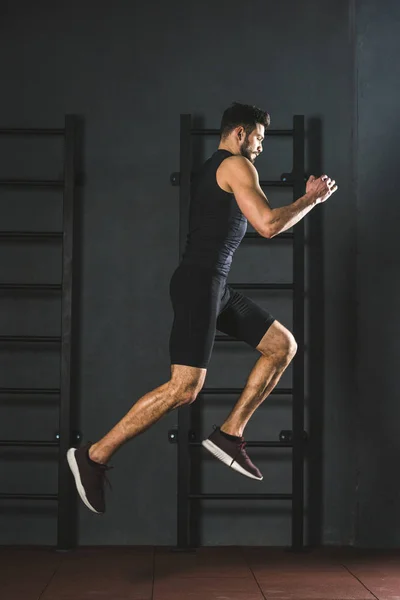 Молодий стрибає спортсмен робить кардіо вправи в спортзалі — стокове фото