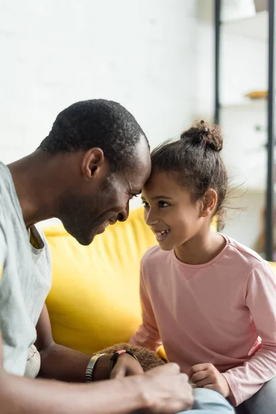 Happy father and daughter looking at each other and touching with foreheads — Stock Photo