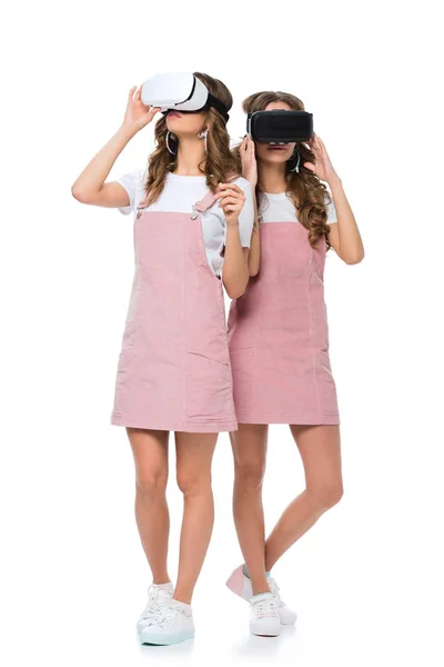 Young twins in virtual reality headsets isolated on white — Stock Photo