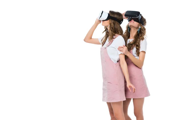 Surprised twins in virtual reality headsets isolated on white — Stock Photo