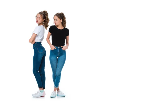 Irritated young twin looking at sister isolated on white — Stock Photo
