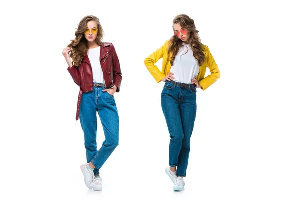 Attractive stylish twins in leather jackets and sunglasses posing isolated on white — Stock Photo