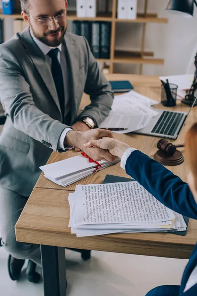 Partial view of lawyers shaking hands on meeting in office — Stock Photo