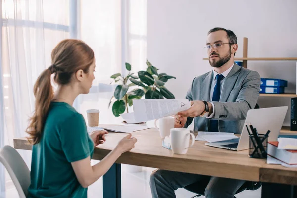 Businessman and client discussing contract during meeting in office — Stock Photo