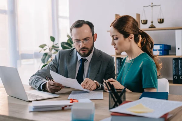 Lawyer and client discussing contract at workplace with laptop in office — Stock Photo