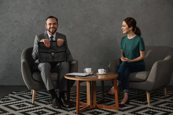 Side view of smiling woman having meeting with lawyer — Stock Photo