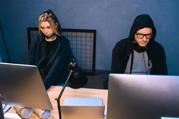 High angle view of thoughtful couple of hackers working on malware together — Stock Photo