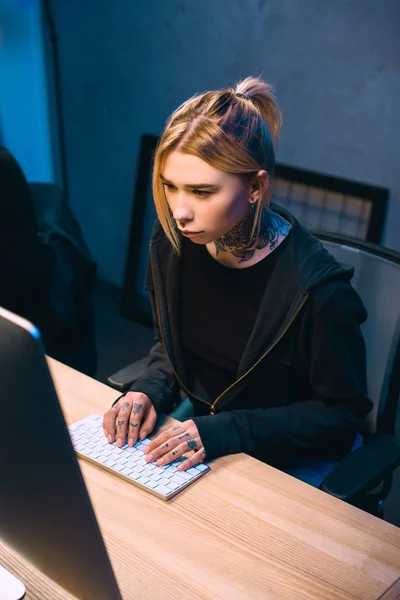 High angle view of serious young female hacker developing malware — Stock Photo