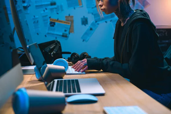 Cropped shot of female hacker developing malware in dark room — Stock Photo