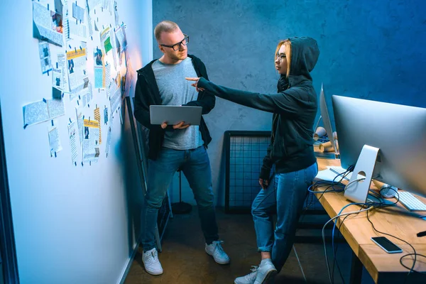 Couple of hackers working on malware together in dark room — Stock Photo