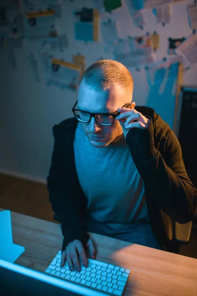 High angle view of serious hacker developing malware in dark room — Stock Photo