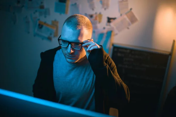 High angle view of young hacker developing malware in dark room — Stock Photo