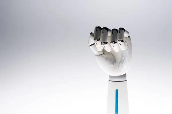 Robot hand showing fist isolated on grey — Stock Photo