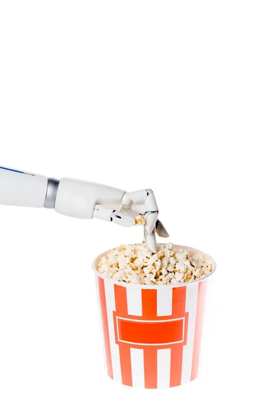 Cropped shot of robot taking tasty popcorn out of bucket isolated on white — Stock Photo