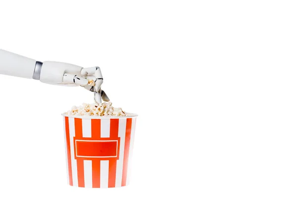 Recortado tiro de robot tomando palomitas de maíz fuera de cubo aislado en blanco - foto de stock